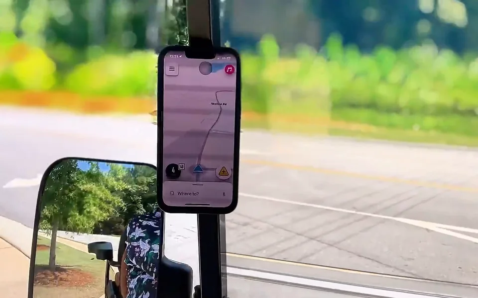 Phone with a navigation map held on a golf cart strut while driving