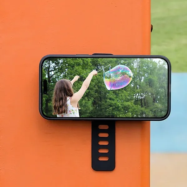 Phone held on a metal post by a magnetic mount for outdoor photography